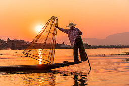 One-leg rower on Inle Lake at sunset on boat trip, Nyaung Shwe, Myanmar