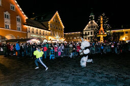 A Krampus runs behind a girl through the old town, Klausenttrieb, Immenstadt im Allgäu, Oberallgäu, Bavaria, Germany, Europe