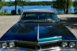 A classic American car stands by a lake in the province of Orebro, Sweden