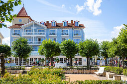 Villa an Strandpromenade in Zinnowtz mit Grünfläche und Touristen auf der Promenade, Usedom, Mecklenburg-Vorpommern, Deutschland