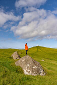 Hiker at Cape Kallur, northern tip of the island Kalsoy, Faroe Islands