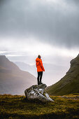 Hiker enjoys the view of the beautiful landscape of the Faroe Islands.