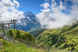Several people stand on Cliff Walk with a view of Eiger, Tissot Cliff Walk, First, Grindelwald, Bernese Oberland, UNESCO World Heritage Site Swiss Alps Jungfrau-Aletsch, Bernese Alps, Bern, Switzerland