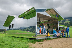 Several people visit Spiegelhaus, Mirror House, architect: Doug Aitken, Gstaad, Simmental, Bernese Alps, Bern, Switzerland