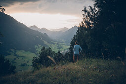 Young woman runs in the evening mood at Falkenstein, Allgäu, Bavaria, Germany