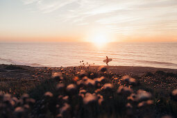 Surfer goes to the sea at sunrise, Portugal, surfing, vacation