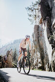 Road biking, woman riding a racing bike on the road