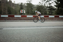 Road biking, woman riding a racing bike on the road