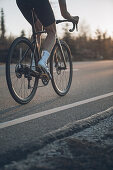 Road biking, woman riding a racing bike on the road