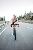 Road biking, woman riding a racing bike on the road