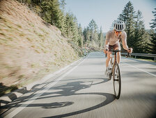 Road biking, woman riding a racing bike on the road