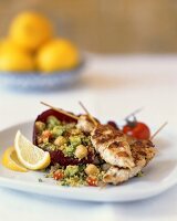 Fried chicken kebabs with couscous & vegetable salad