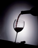 Pouring red wine into a glass