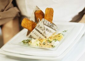 Fish fingers in a paper boat with dips