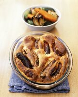 Toad-in-the-hole (sausages baked in batter) with baked vegetables