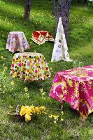 Tables with coloured tablecloths out of doors