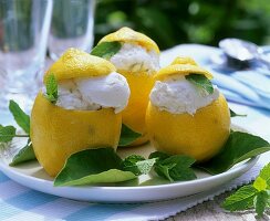Lemon ice cream in hollowed-out lemon with lemon balm