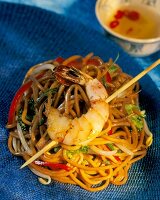 Fried noodles with vegetables and skewered shrimp