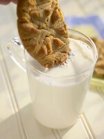 Dunking a Peanut Butter Cookie into a Glass of Milk