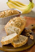 Partially Sliced Banana Nut Loaf Cake; On Cutting Board and Pan