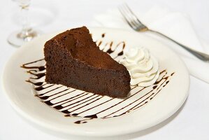 Slice of Flourless Chocolate Cake; Whipped Cream