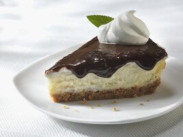 Slice of Cheesecake with Chocolate Sauce Topping and Whipped Cream