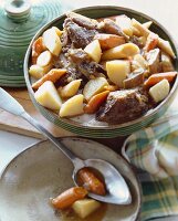 Beef Stew in a Soup Tureen; Spoon with Carrots and Potato in a Bowl