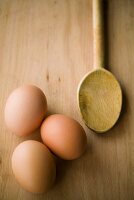 Brown eggs and wooden spoon