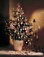 Christmas tree with silver decoration, baubles and lit candles