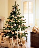 Christmas tree with white decoration, baubles and candles