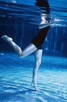 Woman performing aqua jogging in pool