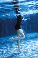 Woman performing aqua jogging in pool