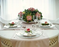 Laid table with ornamental cabbage and rose decoration