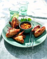 Glazed chicken wings with mango chilli sauce on plate