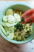 Kartoffelsalat zubereiten (3): Kräuter und Gurke zugeben
