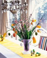 Osterstrauch of tulips and cherry twigs with Easter eggs