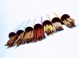 Variety of ayurvedic incense sticks arranged in a row on white background