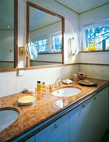 Sink table with marble clad, mirror and art decor fittings in bathroom