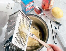 Brushing the grater with basting brush in a bowl