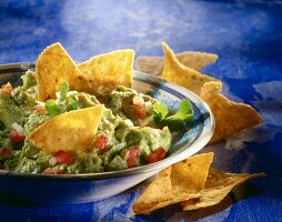 Guacamole with tacos in serving dish