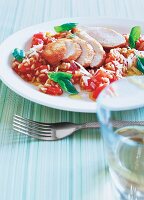 Chicken breast fillets with tomato, ebly, basil and parmesan on plate