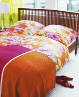 Bed with floral pattern cotton linens in bedroom