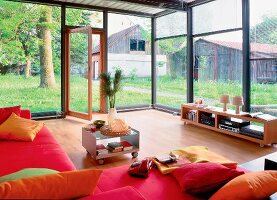 Wohnzimmer mit großzügigen Fenster fronten mit Blick in Garten