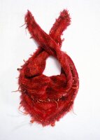 Red woolen cloth with feathers on white background