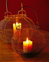 Lit candles in old salad spinners made of wire