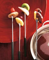 Various fruit pieces stuck on fondue fork