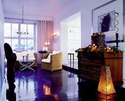 Living room with festively decorated dresser and furniture made of rattan