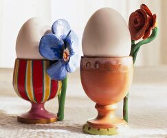 Close-up of decorative eggs in painted cups