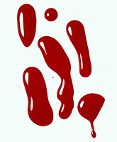 Close-up of red nail polish blobs on white background