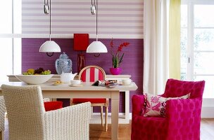View of dining table and striped wallpaper in dining area
